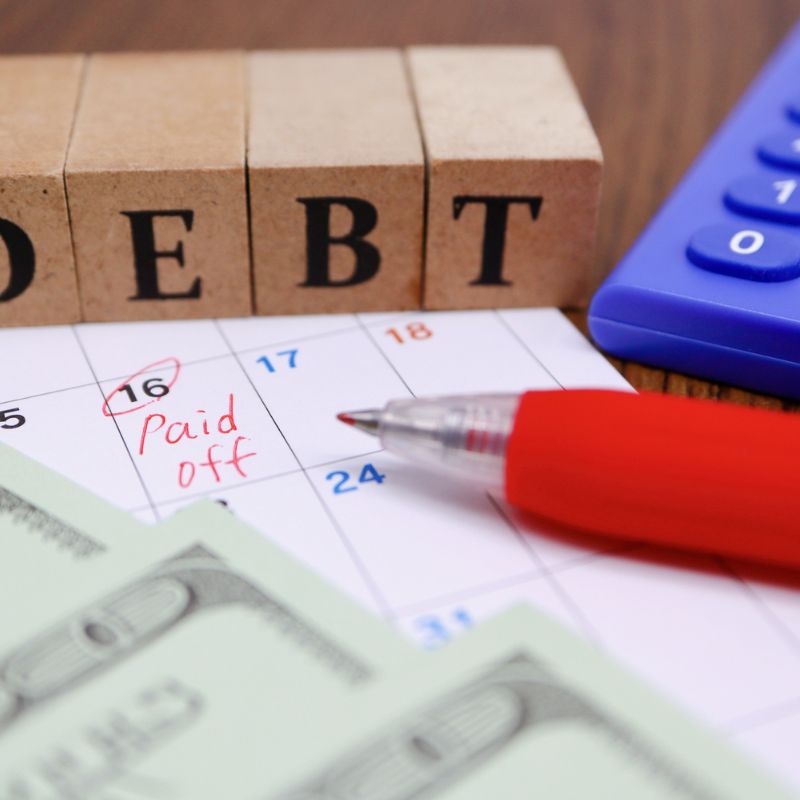 Person reviewing debt payoff calendar and planning personal finances