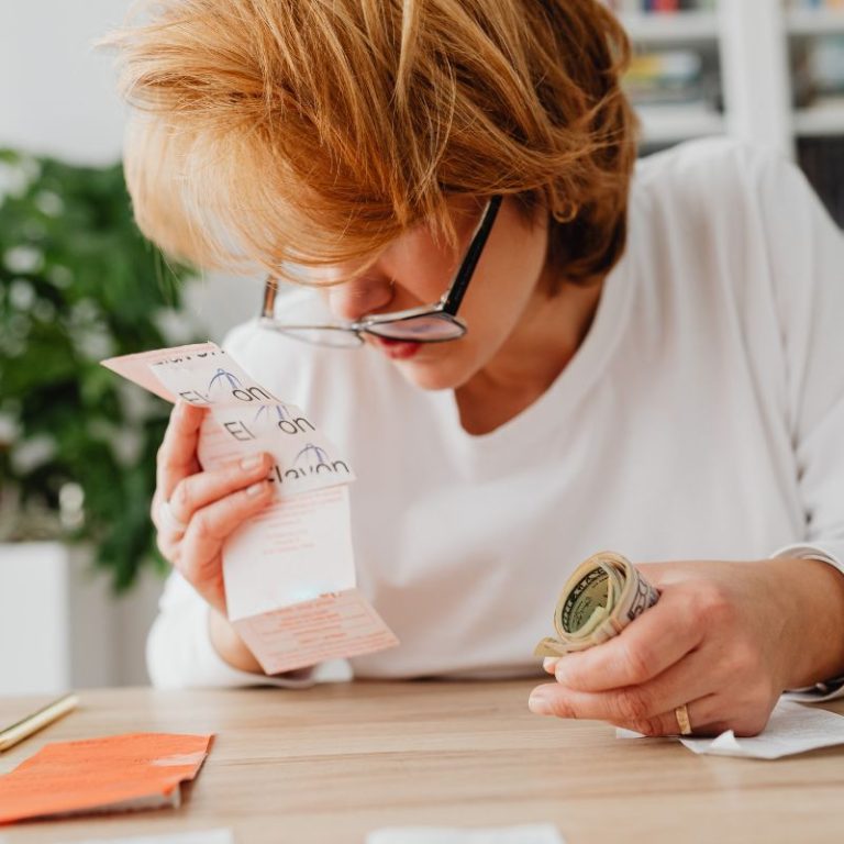 Woman reviewing debt management strategies — a step-by-step guide to managing and eliminating debt effectively