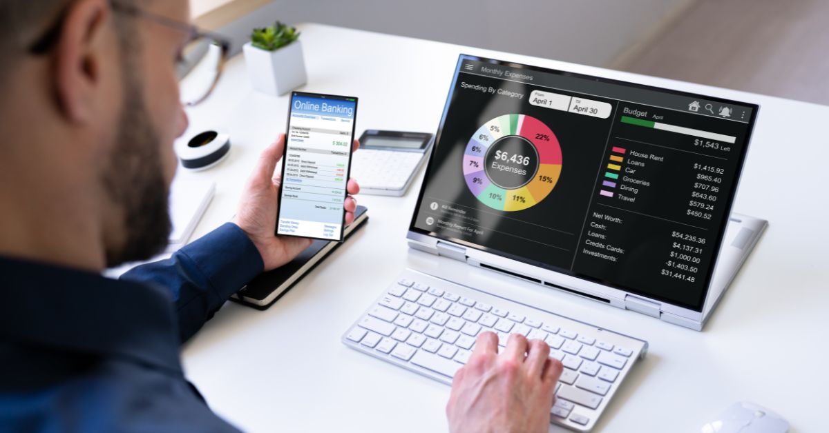 man using budgeting app on laptop to track finances