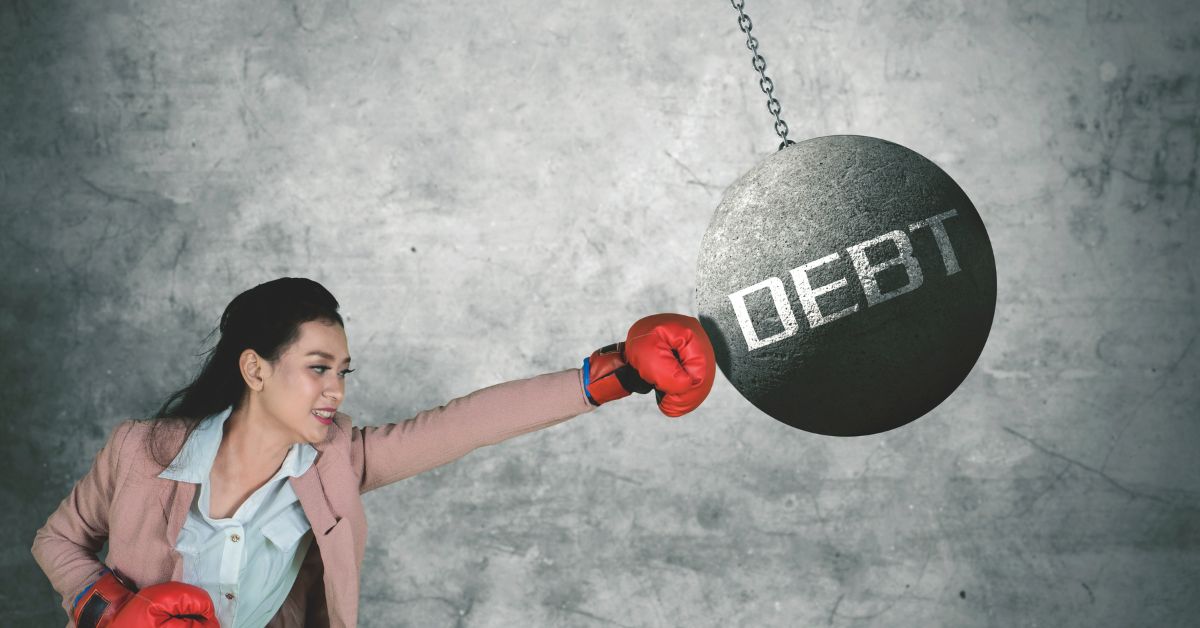 woman fighting debt with boxing gloves