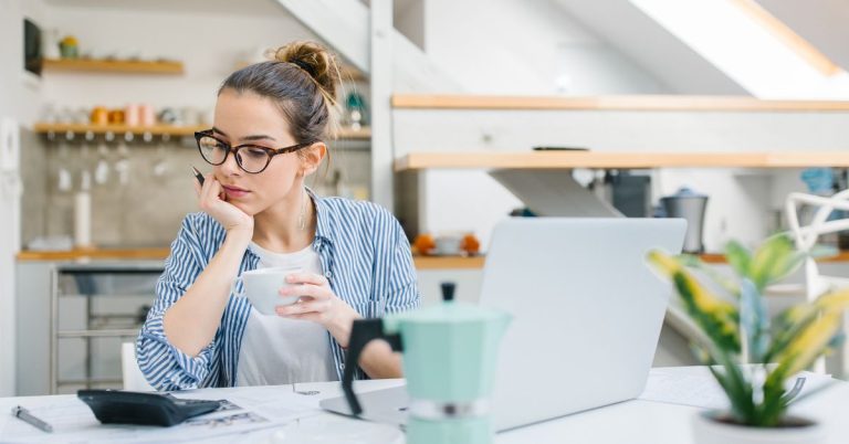 Woman reviewing budget and managing personal finances at home
