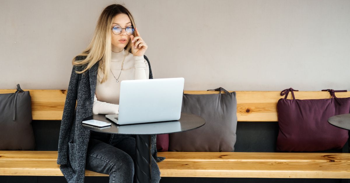 Woman working on laptop — how to design a life that pays you through multiple income streams and smart financial decisions